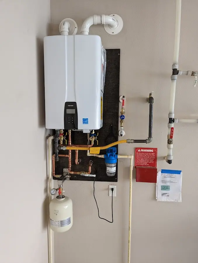 Professional plumber installing copper piping in a Priceville home